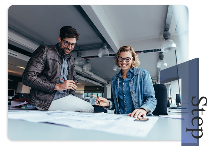 photo of a man and woman looking over blueprints