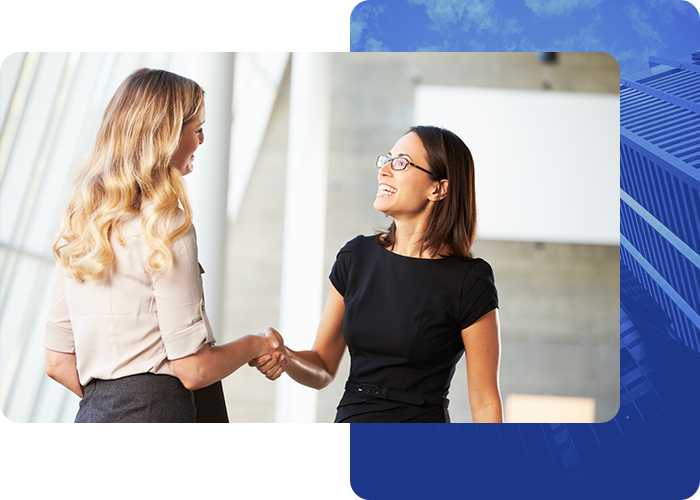 photo of two business women shaking harnds