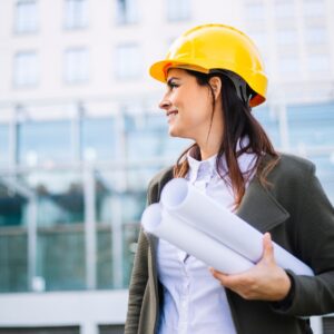 photo of a female engineer carrying blueprints